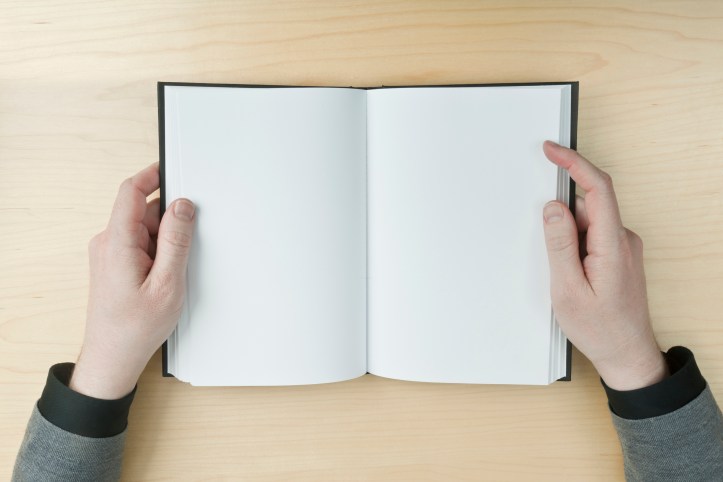 Man reading a blank book